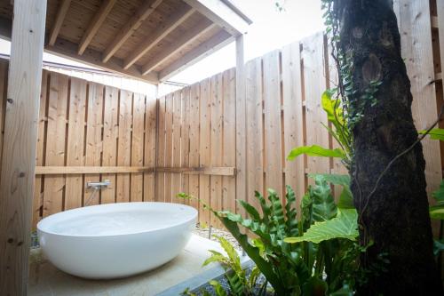 a bath tub in a bathroom with a wooden wall at Villa Muse Okinawa- Vacation STAY 43823v in Nago