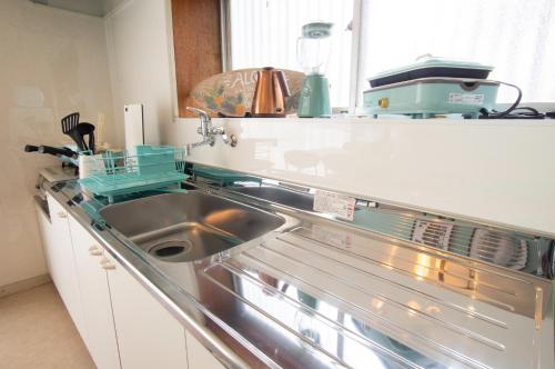 a kitchen with a stainless steel sink and a dishwasher at VIILENT KUJUKURI Ocean1 - Vacation STAY 33286v in Kujukuri
