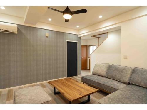 a living room with a couch and a table at Stardust Motobu - Vacation STAY 45756v in Motobu