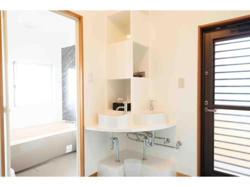 a bathroom with two sinks and a toilet at Stardust Motobu - Vacation STAY 45756v in Motobu