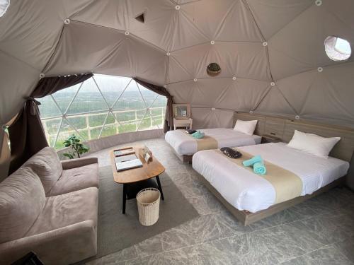 two beds in a tent with a table and a couch at Blissful Garden - Vacation STAY 46392v in Shibukawa