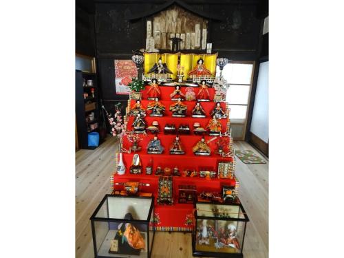 a display of toys on a red shelf at Minshuku Otaki fireplace - Vacation STAY 46344v in Miyaki