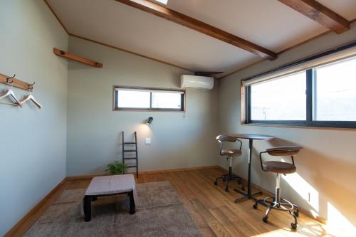a room with a table and chairs and a window at CANOA GUEST HOUSE A room - Vacation STAY 50937v in Ikeda