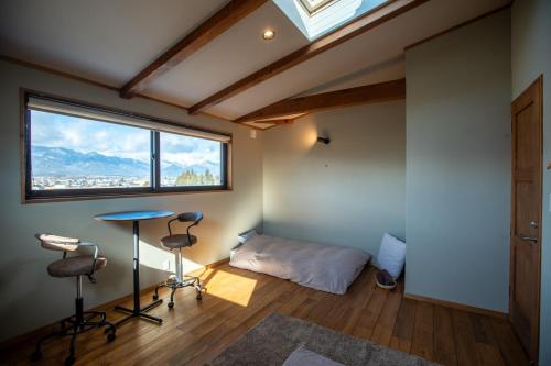 a room with a bed and a table and chairs at CANOA GUEST HOUSE B room- Vacation STAY 47218v in Ikeda