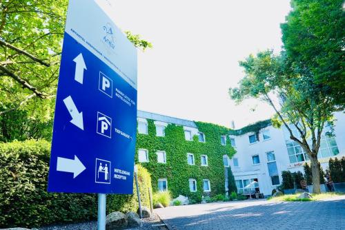 a blue street sign in front of a building at Arthotel Ambassador Wiesbaden - FREE PARKING in Wiesbaden