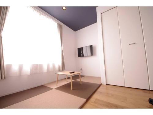 a room with a table and a large window at HOTEL APT SESELA - Vacation STAY 12878 in Kanazawa