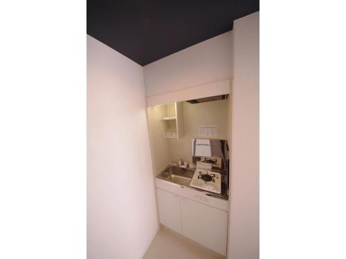 a bathroom with a sink and a mirror at HOTEL APT SESELA - Vacation STAY 12878 in Kanazawa