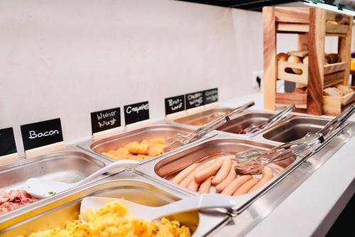 a buffet line with a lot of food at Arthotel Ambassador Wiesbaden - FREE PARKING in Wiesbaden