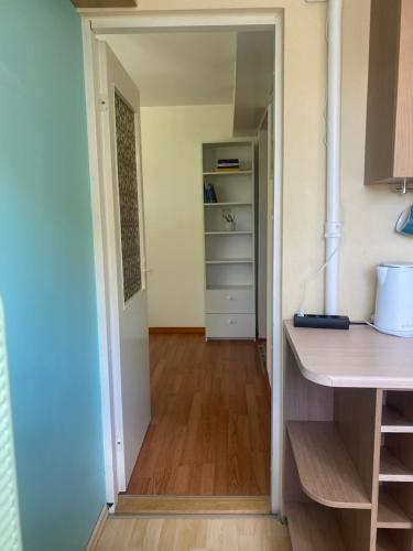 a hallway leading into a kitchen with a closet at Cosy Studio in Tartu Center in Tartu