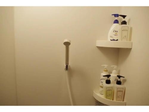 a bathroom with a toilet with some bottles of soap at base sanablend - Vacation STAY 37411v in Kyotango