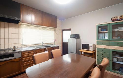 a kitchen with a wooden table and chairs in a kitchen at WABI - Vacation STAY 52963v in Kanazawa