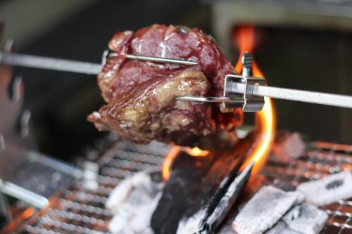a piece of meat cooking on a grill at Minamitsuru-gun - Cottage - Vacation STAY 96482v in Yamanakako