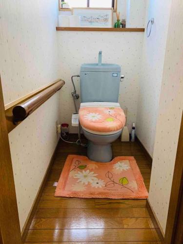 a bathroom with a toilet with a rug on the floor at HOSTEL UKS - Vacation STAY 13007 in Nagoya