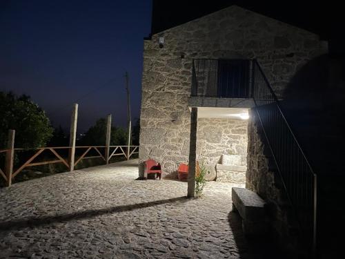 a building with a light on the side of it at night at Quinta Cerca da Milhera - Unique Experiences by LuxiStay in Ponte da Barca