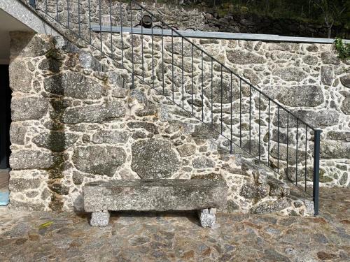 a stone bench sitting next to a stone staircase at Quinta Cerca da Milhera - Unique Experiences by LuxiStay in Ponte da Barca