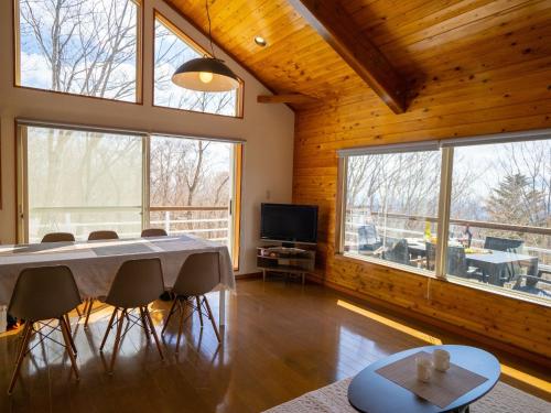 a dining room with a table and some windows at Baberu - Vacation STAY 13021 in Nasushiobara