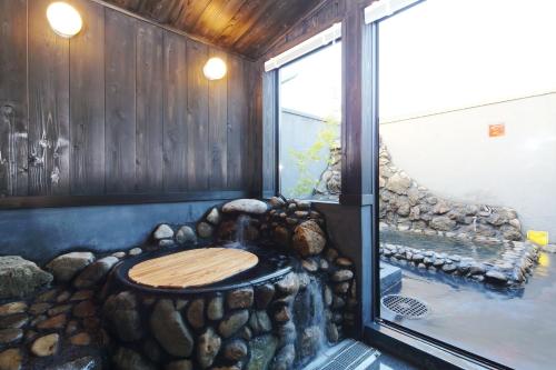 a room with a large window with a wooden wall at Nagatoro fireplace - Vacation STAY 59551v in Minano