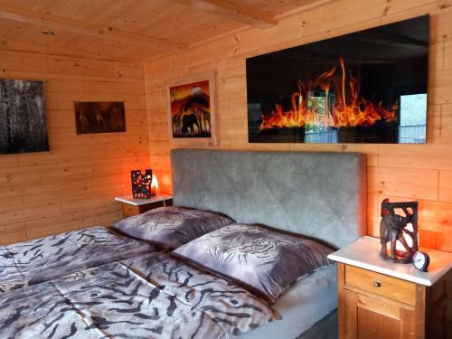 a bedroom with a bed and a fireplace at Alm-Chalet in der Nähe vom Klippitztörl 