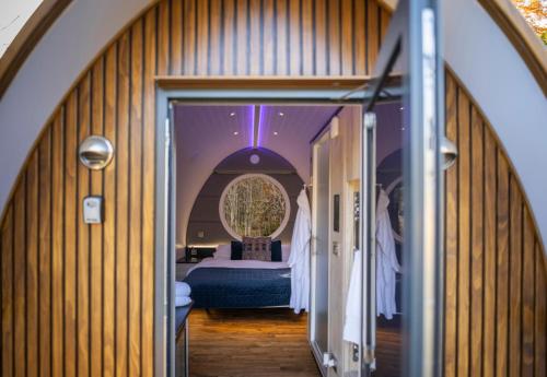 a hallway leading to a bedroom with a bed at Murrayshall Country Estate in Perth