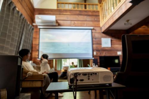 a tv in a living room with a table with a radio at Log House Kizuki - Vacation STAY 62486v in Tsuru 