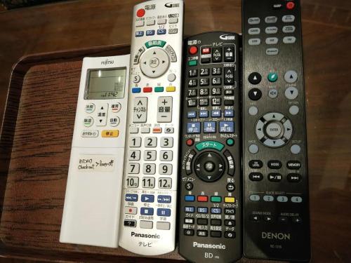four remote controls sitting next to each other on a table at Log House Kizuki - Vacation STAY 62486v in Tsuru 