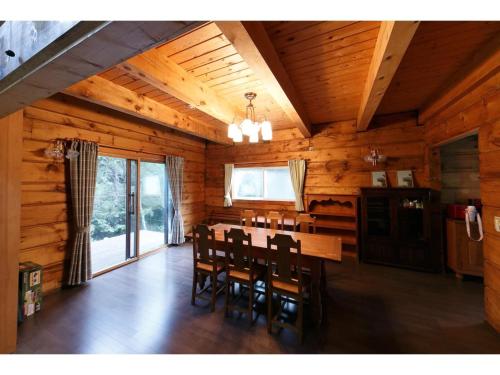 a dining room with a table and chairs in a cabin at Log House Seseragi - Vacation STAY 62500v in Tsuru 