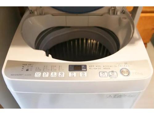 a close up of a washing machine with its door open at Log House Seseragi - Vacation STAY 62500v in Tsuru 
