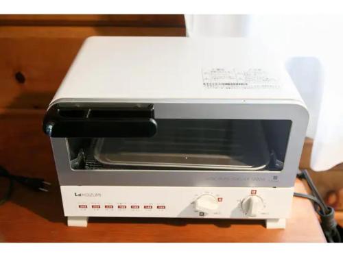 a toaster oven sitting on top of a counter at Log House Seseragi - Vacation STAY 62500v in Tsuru 