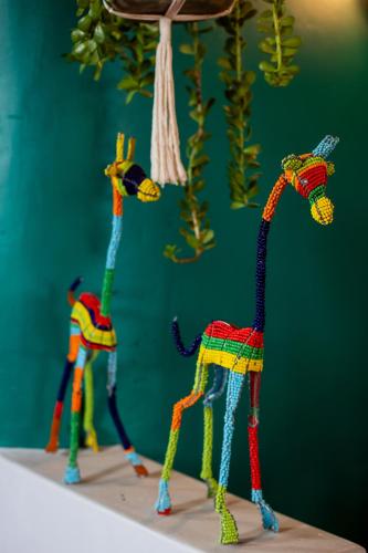 a group of colorful toy animals on a table at Chameleon Hill Forest Lodge in Bwindi
