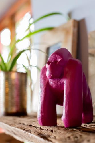 a pink elephant toy sitting on a table at Chameleon Hill Forest Lodge in Bwindi