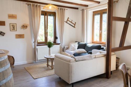 a living room with a couch and a table at Au vignoble 94 in Kaysersberg