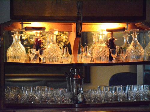 a bunch of glasses sitting on a shelf at Holiday home in Bièvre near town center in Bièvre