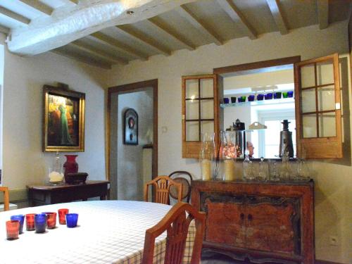 a dining room with a table and a mirror at Holiday home in Bièvre near town center in Bièvre