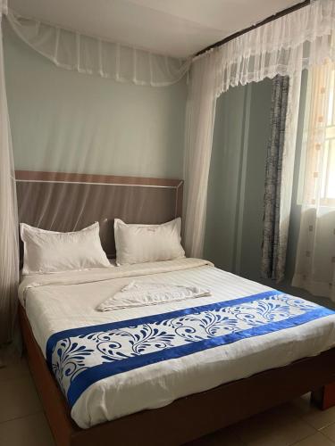 Ένα ή περισσότερα κρεβάτια σε δωμάτιο στο Kyasina Hotel