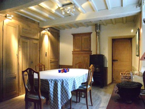 a dining room with a table and chairs in a kitchen at Holiday home in Bièvre near town center in Bièvre