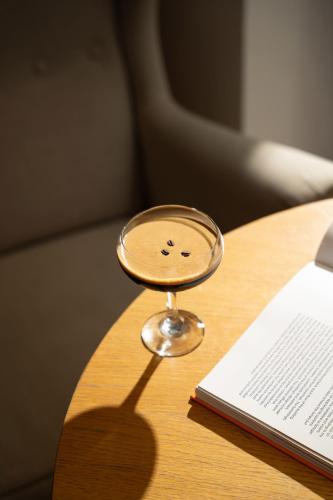a magnifying glass sitting on a table next to a book at INNSiDE by Meliá Prague Old Town in Prague