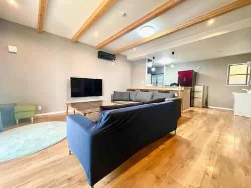 a living room with a couch and a tv at BEACH HOUSE Kamogawa - Vacation STAY 64005v in Kamogawa