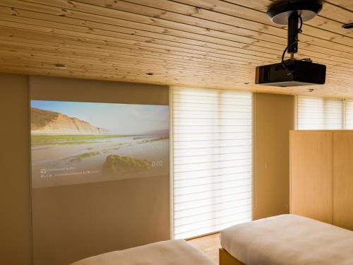 a bedroom with a large window and a large screen at Rakuten STAY VILLA Aso Kurokawa -102 1LDK Capacity of 6 persons in Minamioguni