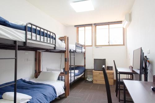 a dorm room with bunk beds and a desk at TABIHAKU STAY Kasumi - Vacation STAY 70463v in Kami