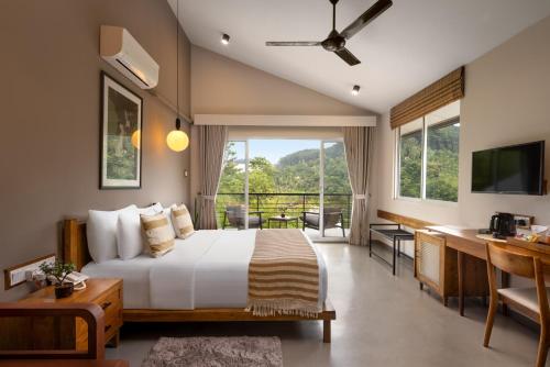 a bedroom with a large bed and a balcony at The Cubes Ella in Ella
