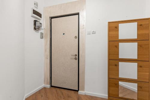 a door in a room with a wooden dresser at Golden Crown Suite in Bucharest