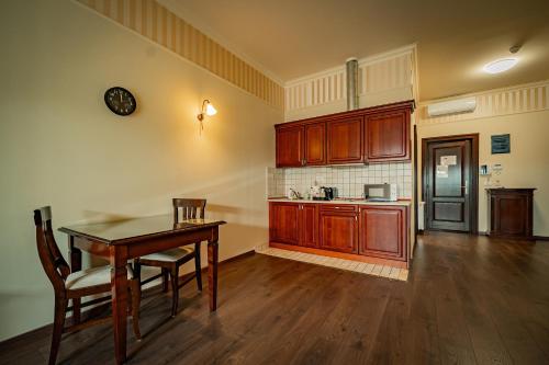 an empty kitchen with a table and a counter top at Aparthotel Iosefin Residence in Timişoara
