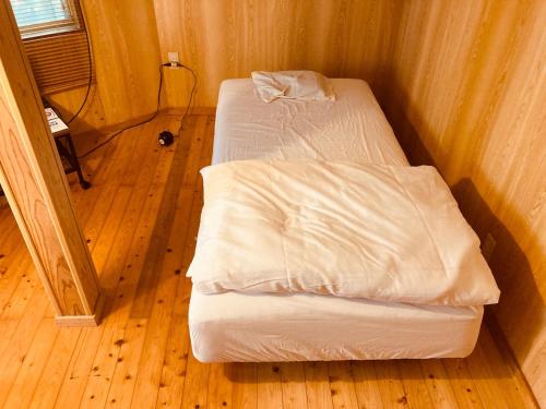 a pair of beds in a room with wood floors at Guesthouse Nichinan - Vacation STAY 82905v in Nichinan