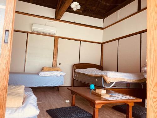a room with two bunk beds and a table at Guesthouse Nichinan - Vacation STAY 82913v in Nichinan