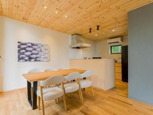 a kitchen and dining room with a wooden table and chairs at Rakuten STAY VILLA Aso Kurokawa -105 1LDK pet allowed Capacity of 6 persons in Minamioguni