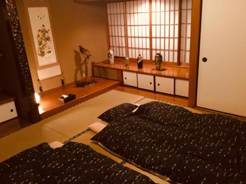 a bedroom with a large bed and a window at Shima no Yado 〜KON〜 - Vacation STAY 67964v in Oshima