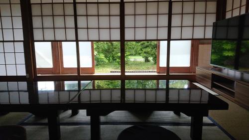a view of a room with windows and a table at Kuonsou - Vacation STAY 90948v in Iwada