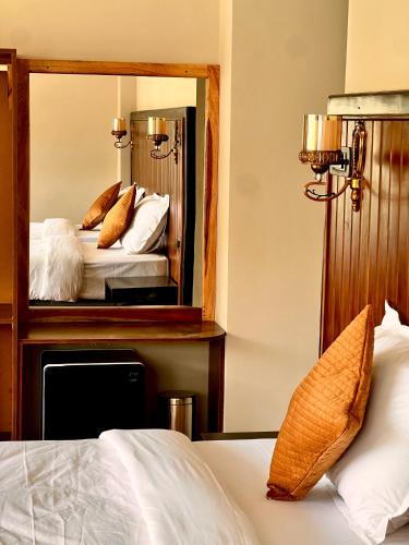 a bedroom with a large mirror on the wall at Star Residency in Paro