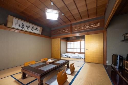 a room with a table and chairs and a bed at Chizu - Vacation STAY 83974v in Mitoyo