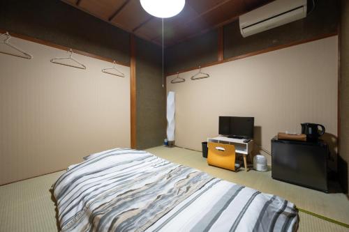 a bedroom with a bed and a tv in it at Chizu - Vacation STAY 83928v in Mitoyo